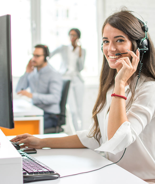Image of a phone operator, smiling towards the viewer, representing contacting Mier Recruitment