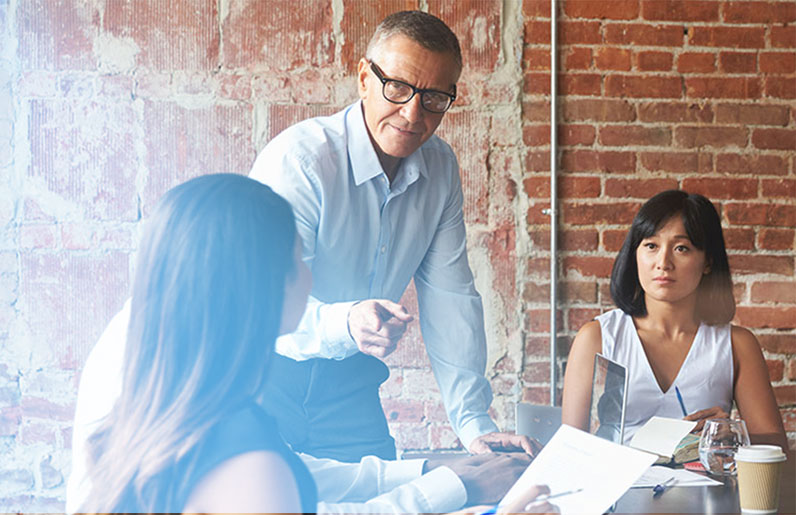 Image of three business people brainstorming new concepts - representing how Mier Human Capital came to be and how they help other businesses